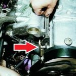 The red arrow indicates the sensor screwed into the engine hole